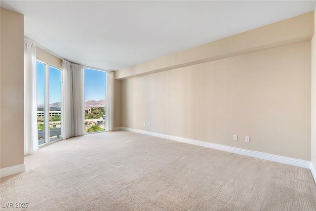 2857 Paradise Rd Unit 802, Las Vegas, NV 89109 - unfurnished room featuring carpet, baseboards, and expansive windows