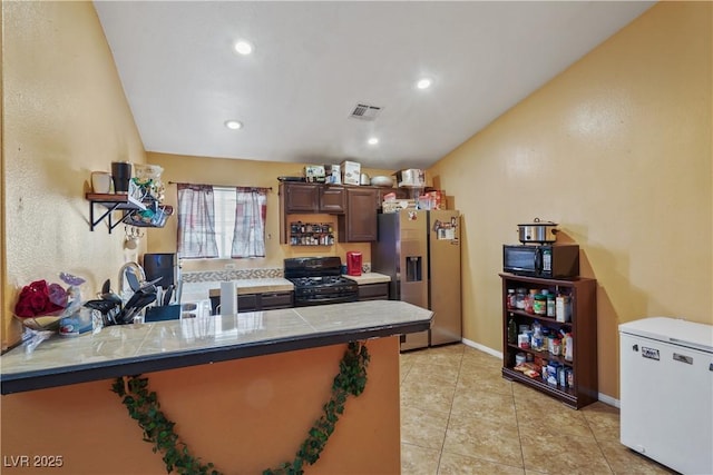 kitchen with black appliances, a peninsula, light tile patterned flooring, recessed lighting, and baseboards