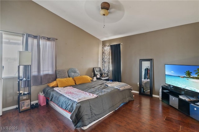 bedroom with wood finished floors, baseboards, ceiling fan, and high vaulted ceiling