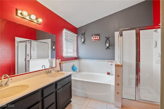 full bath featuring tile patterned floors, a stall shower, a garden tub, double vanity, and tile walls