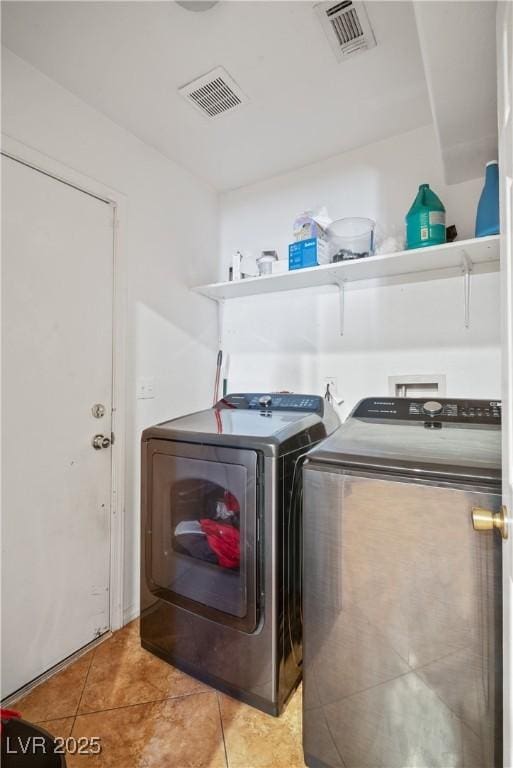 washroom with independent washer and dryer and light tile patterned floors