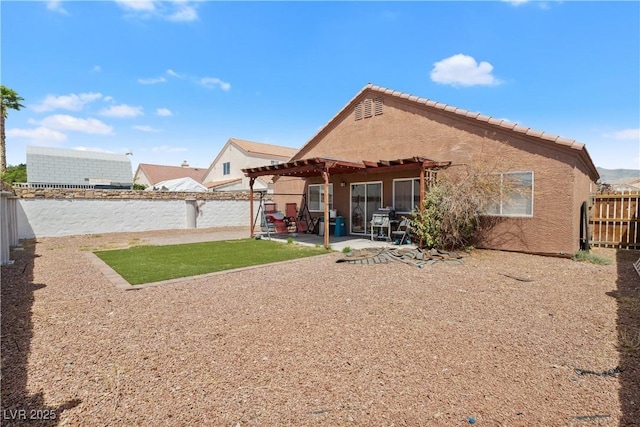 back of house with a pergola, a fenced backyard, stucco siding, and a patio