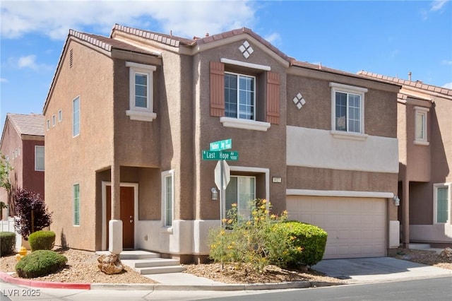 multi unit property featuring stucco siding, driveway, and an attached garage