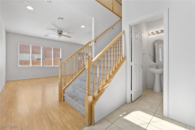 stairs with ceiling fan, baseboards, recessed lighting, and wood finished floors