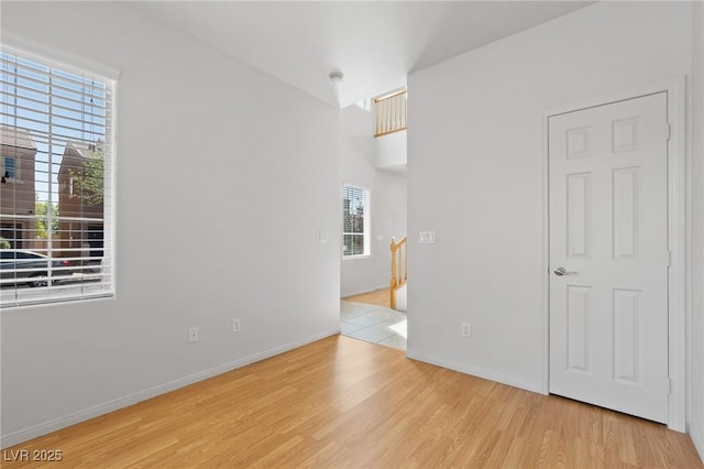 spare room with wood finished floors and baseboards