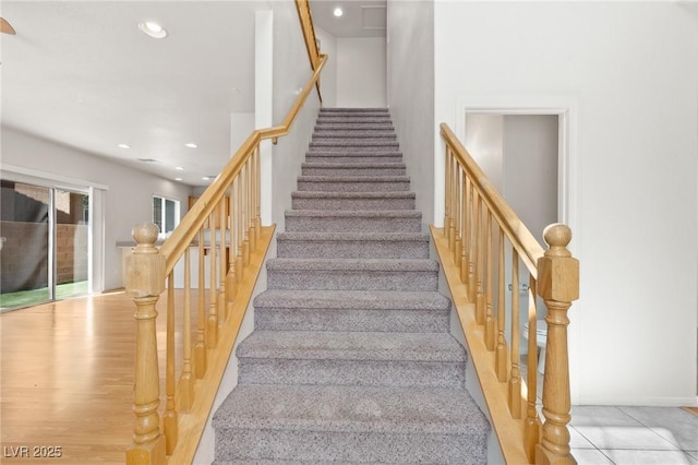 staircase featuring recessed lighting and wood finished floors