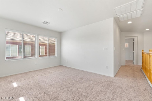 unfurnished room with light colored carpet, recessed lighting, and baseboards