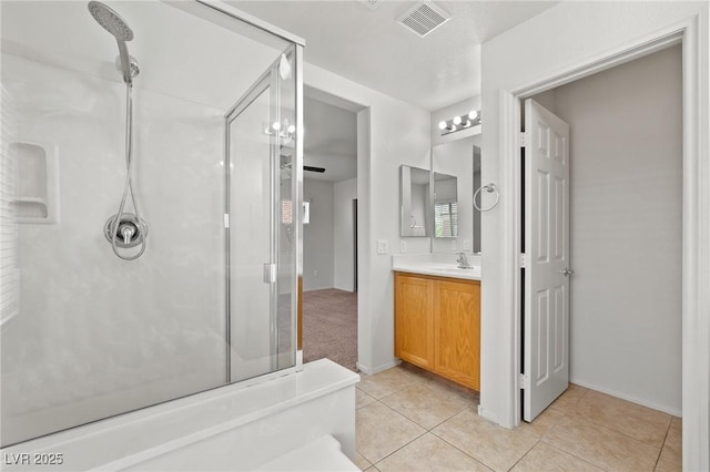 bathroom featuring a shower stall, tile patterned flooring, vanity, and baseboards