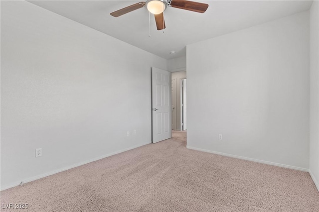 unfurnished room with light colored carpet, ceiling fan, and baseboards