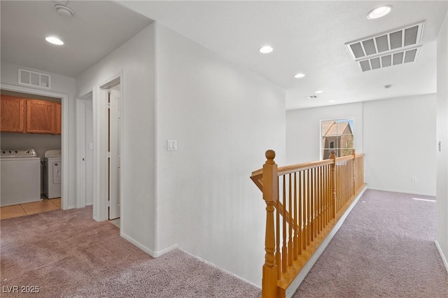 hallway with light carpet, washer and dryer, an upstairs landing, recessed lighting, and baseboards