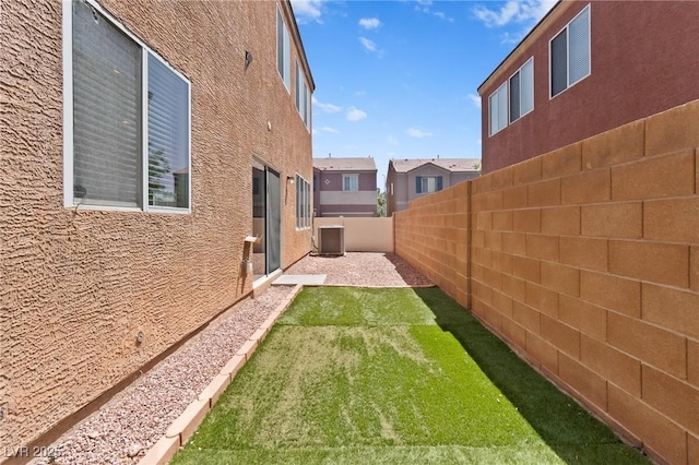 view of yard with cooling unit and a patio