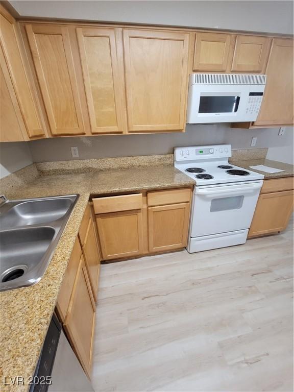 3151 Soaring Gulls Dr Unit 2101, Las Vegas, NV 89128 - kitchen with white appliances, a sink, light wood finished floors, light brown cabinets, and light countertops