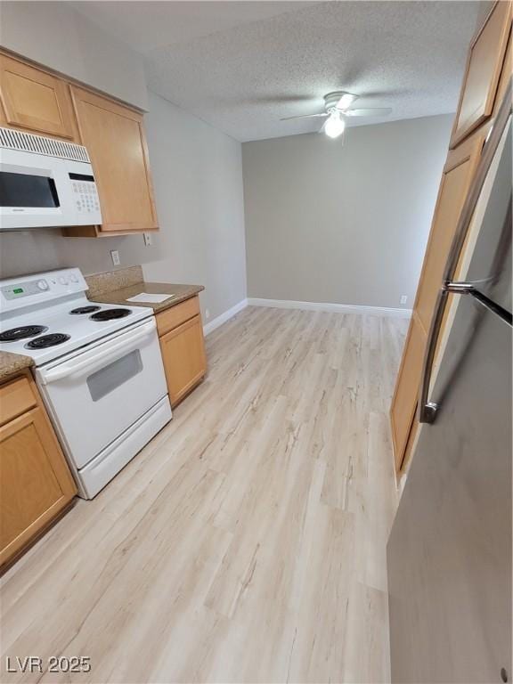 3151 Soaring Gulls Dr Unit 2101, Las Vegas, NV 89128 - kitchen featuring white appliances, light wood-style floors, light brown cabinets, ceiling fan, and a textured ceiling