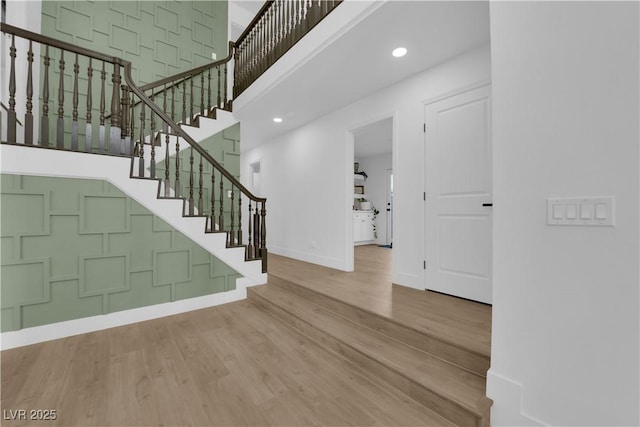 2160 Pueblo Cir, Las Vegas, NV 89169 - entryway featuring wood finished floors, a high ceiling, baseboards, stairway, and recessed lighting
