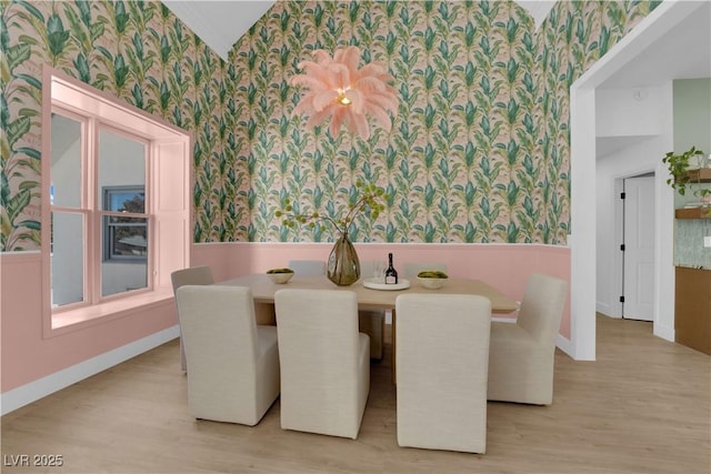 2160 Pueblo Cir, Las Vegas, NV 89169 - dining room featuring wallpapered walls, a wainscoted wall, wood finished floors, baseboards, and lofted ceiling