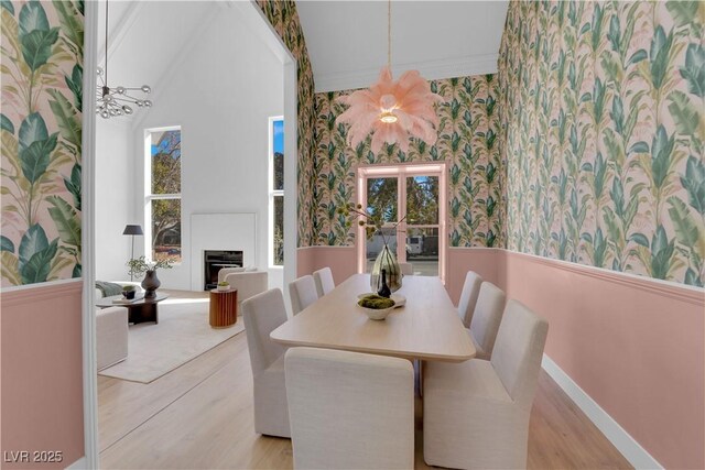 2160 Pueblo Cir, Las Vegas, NV 89169 - dining space featuring wallpapered walls, a wainscoted wall, wood finished floors, plenty of natural light, and crown molding
