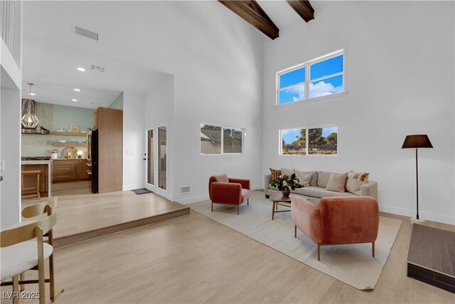 2160 Pueblo Cir, Las Vegas, NV 89169 - living area featuring a high ceiling, light wood finished floors, beam ceiling, recessed lighting, and baseboards