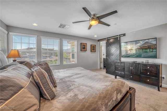 bedroom featuring a barn door, carpet, baseboards, ceiling fan, and recessed lighting