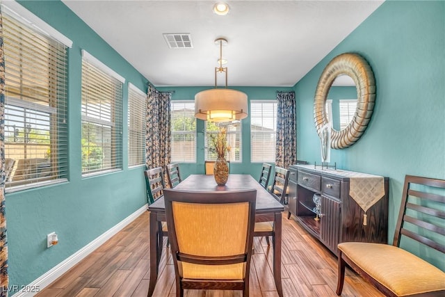 dining space featuring wood finished floors and baseboards