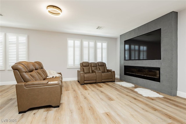 8095 Carpenter Creek Ave, Las Vegas, NV 89113 - living area featuring a fireplace, wood finished floors, and baseboards