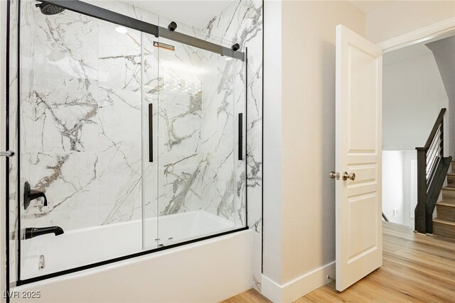 8095 Carpenter Creek Ave, Las Vegas, NV 89113 - full bath with bath / shower combo with glass door, wood finished floors, and baseboards