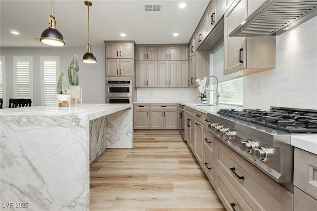 8095 Carpenter Creek Ave, Las Vegas, NV 89113 - kitchen featuring stainless steel appliances, range hood, a sink, light wood-type flooring, and decorative backsplash