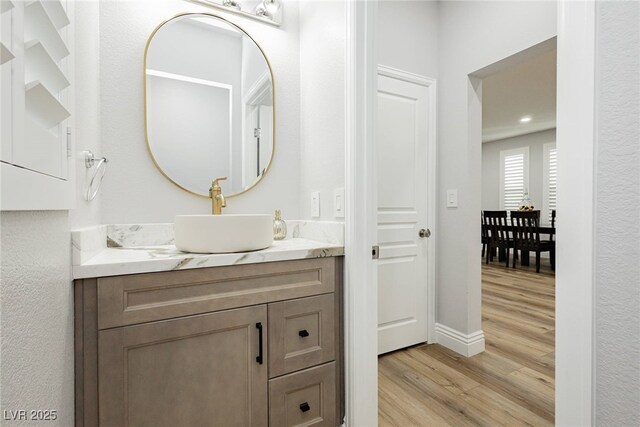 8095 Carpenter Creek Ave, Las Vegas, NV 89113 - bathroom featuring wood finished floors, vanity, and baseboards