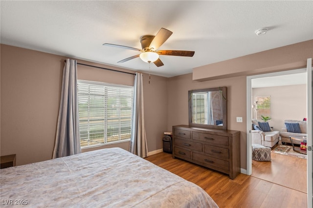 3125 N Buffalo Dr Unit 1103, Las Vegas, NV 89128 - bedroom featuring wood finished floors, baseboards, and ceiling fan