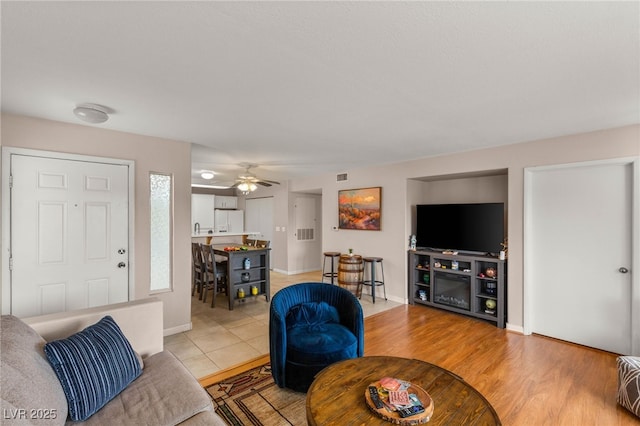 3125 N Buffalo Dr Unit 1103, Las Vegas, NV 89128 - living area with ceiling fan, light wood-style flooring, and baseboards