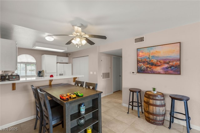 3125 N Buffalo Dr Unit 1103, Las Vegas, NV 89128 - dining space with light tile patterned floors, a ceiling fan, and baseboards