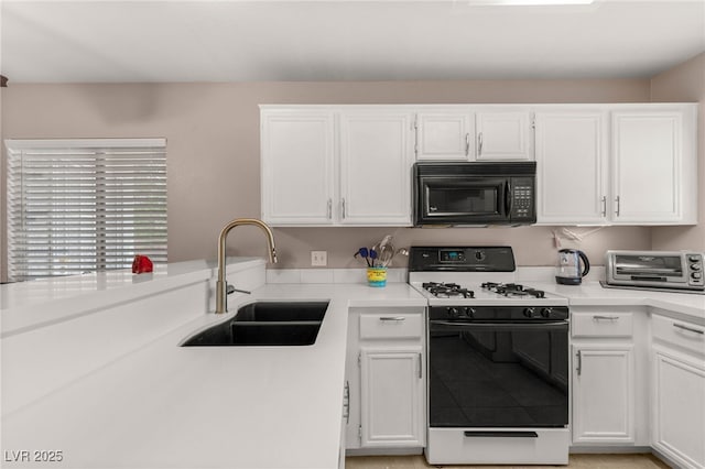 3125 N Buffalo Dr Unit 1103, Las Vegas, NV 89128 - kitchen with gas range gas stove, black microwave, a sink, white cabinets, and light countertops