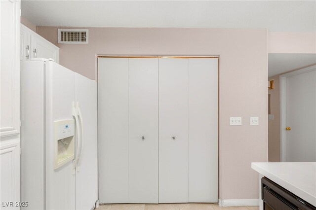 3125 N Buffalo Dr Unit 1103, Las Vegas, NV 89128 - kitchen featuring white fridge with ice dispenser, light countertops, and white cabinets