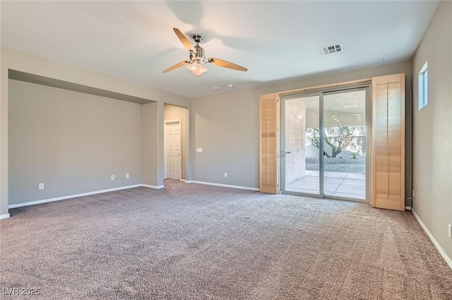 spare room featuring a ceiling fan, carpet, and baseboards