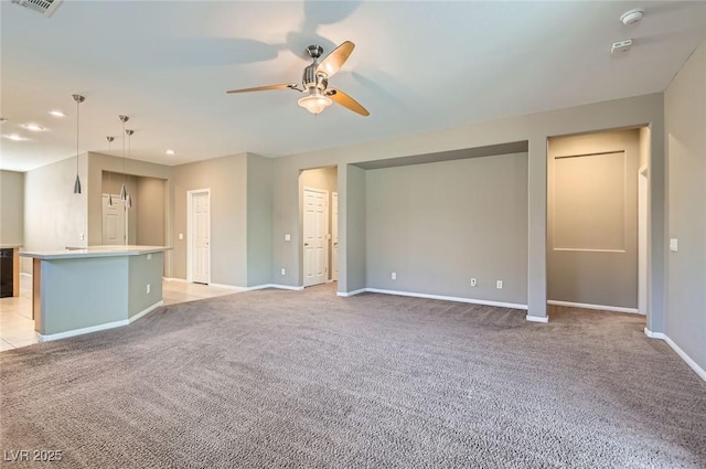 unfurnished living room with a ceiling fan, light carpet, baseboards, and recessed lighting