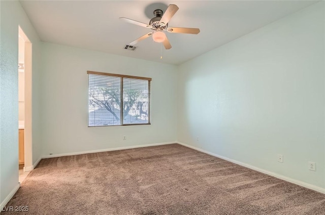 empty room with light colored carpet, ceiling fan, and baseboards