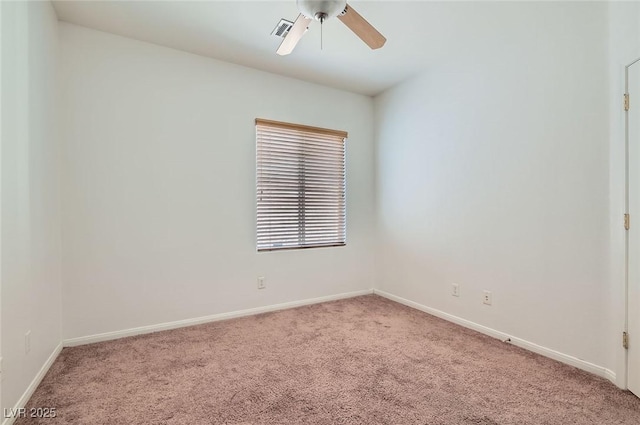 empty room with light colored carpet, ceiling fan, and baseboards