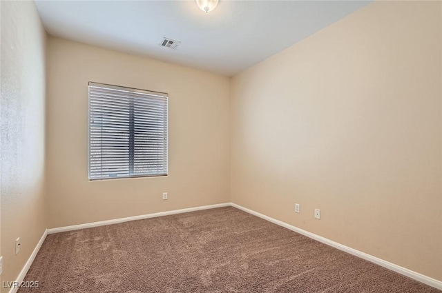 unfurnished room with carpet floors and baseboards