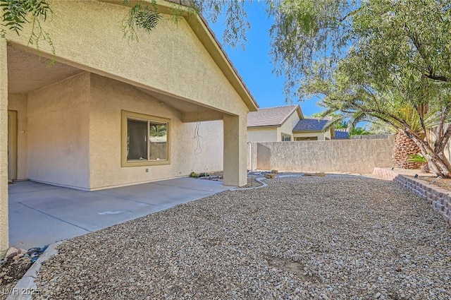view of yard featuring fence and a patio
