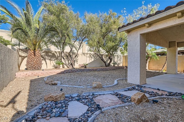 fenced backyard featuring a patio