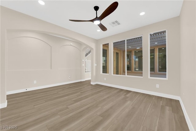 177 Rocky Star St, Henderson, NV 89012 - unfurnished room with ceiling fan, arched walkways, baseboards, wood finished floors, and recessed lighting