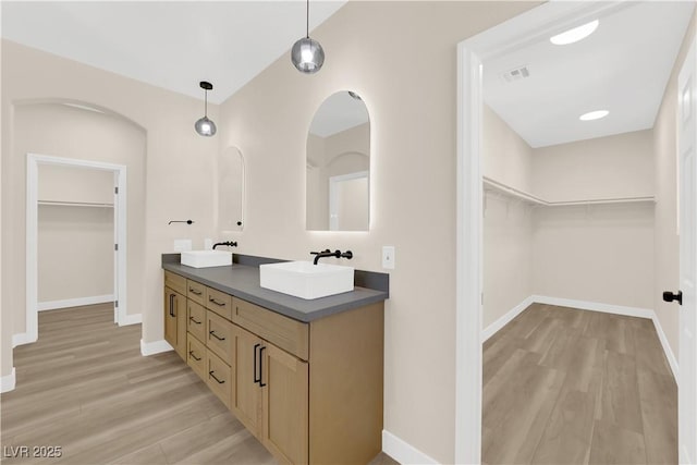 177 Rocky Star St, Henderson, NV 89012 - full bath featuring double vanity, a walk in closet, wood finished floors, and baseboards