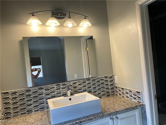bathroom featuring tasteful backsplash and vanity