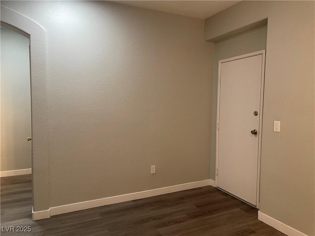 9333 Leaping Deer Pl Unit 103, Las Vegas, NV 89178 - empty room with dark wood-style flooring and baseboards