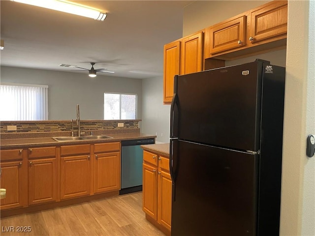 9333 Leaping Deer Pl Unit 103, Las Vegas, NV 89178 - kitchen with freestanding refrigerator, dishwasher, a sink, a ceiling fan, and light wood-style flooring