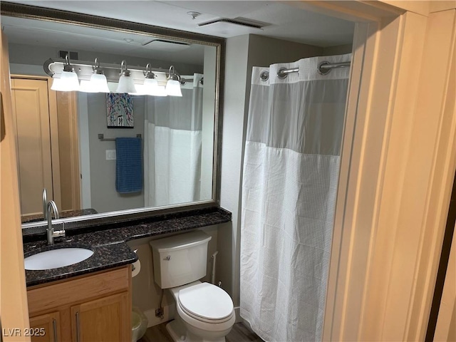 260 E Flamingo Rd Unit 228, Las Vegas, NV 89169 - bathroom featuring toilet, vanity, and a shower with shower curtain