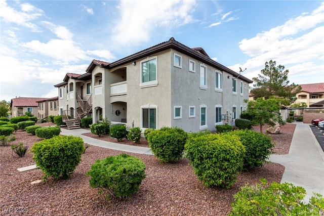 view of home's exterior featuring stucco siding and stairway