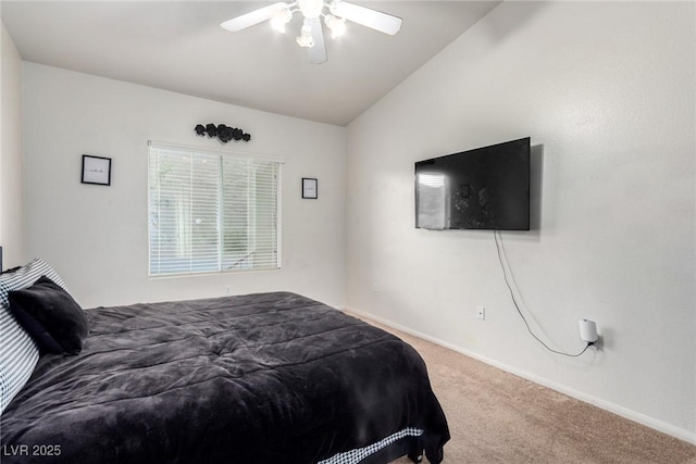 bedroom with carpet floors, baseboards, vaulted ceiling, and a ceiling fan