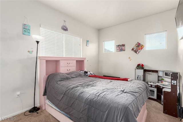 bedroom with light carpet and baseboards
