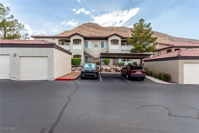 view of front of house featuring stucco siding and stairway