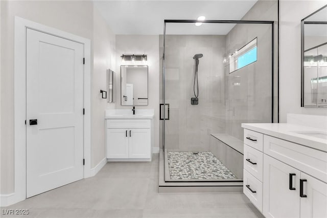 10345 Howling Coyote Ave, Las Vegas, NV 89135 - full bathroom featuring a shower stall, two vanities, baseboards, and recessed lighting